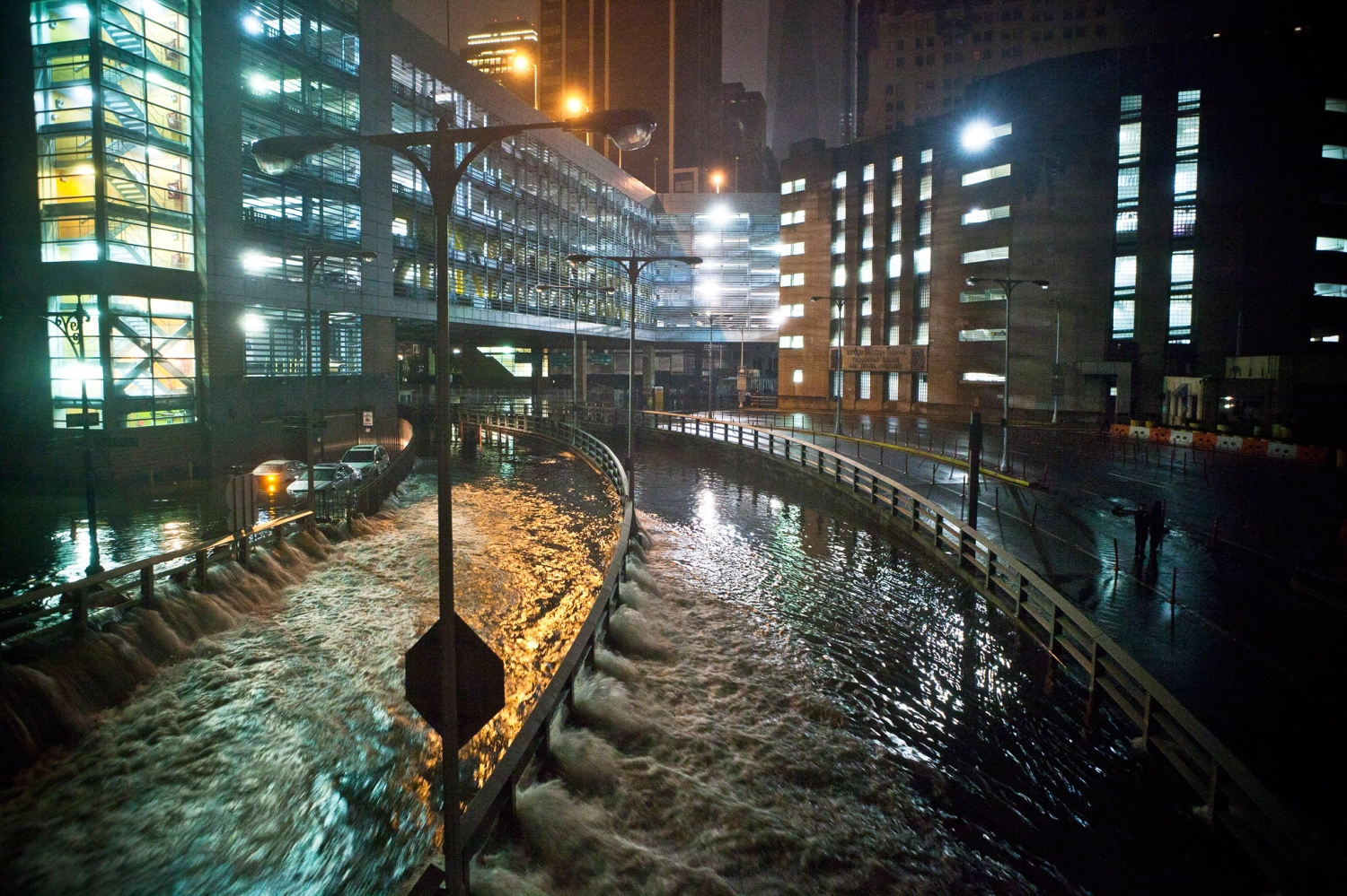 Flooded city streets and bridges at night during hurricane sandy