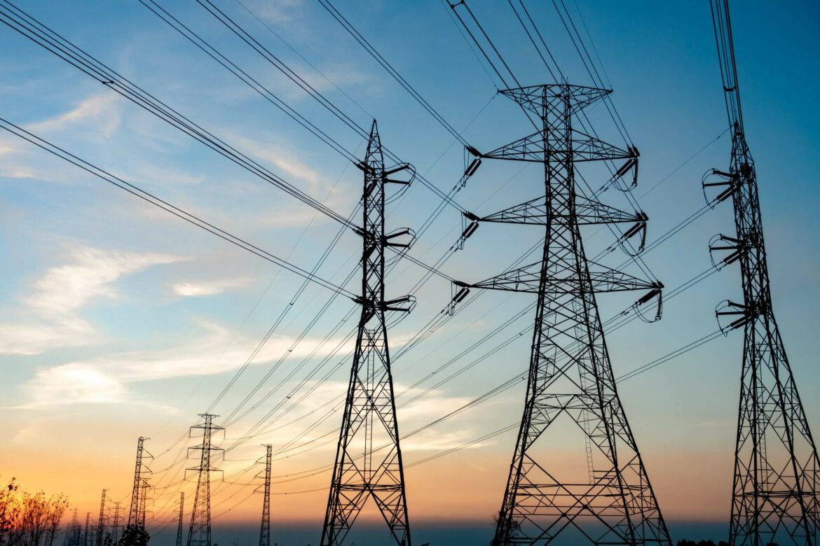 Electric Pylons and electric lines sunset sky
