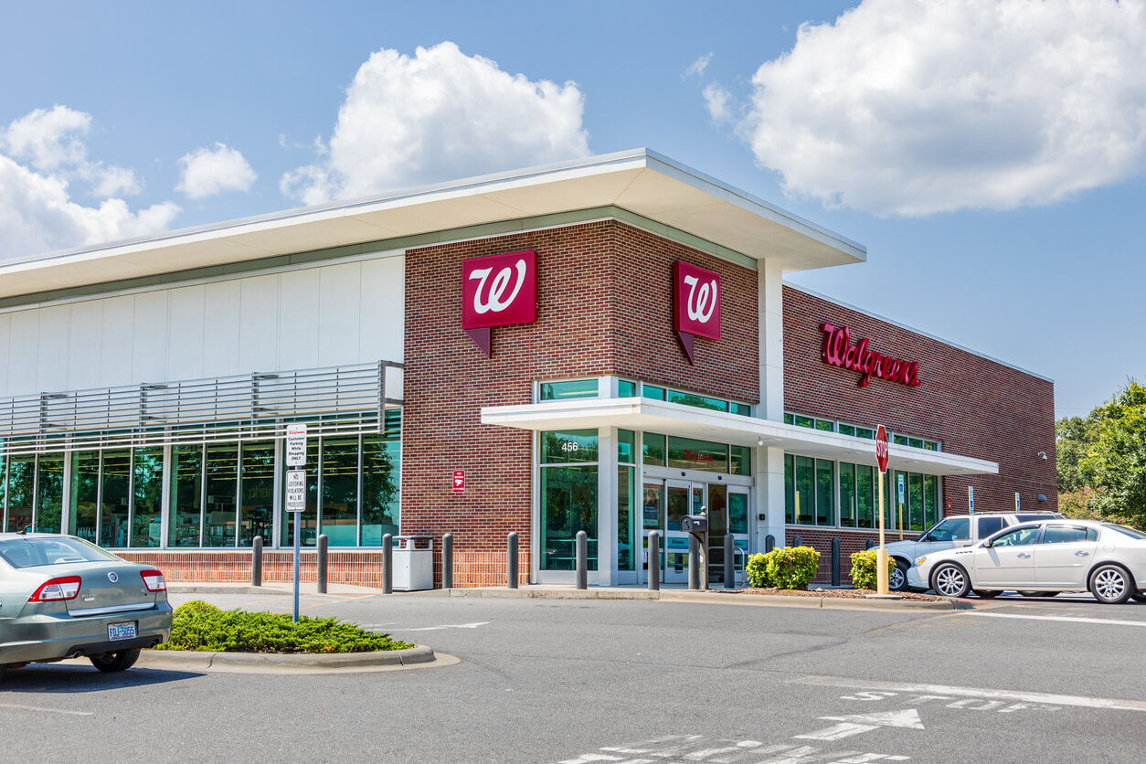Walgreens building entrance and parking lot during daylight
