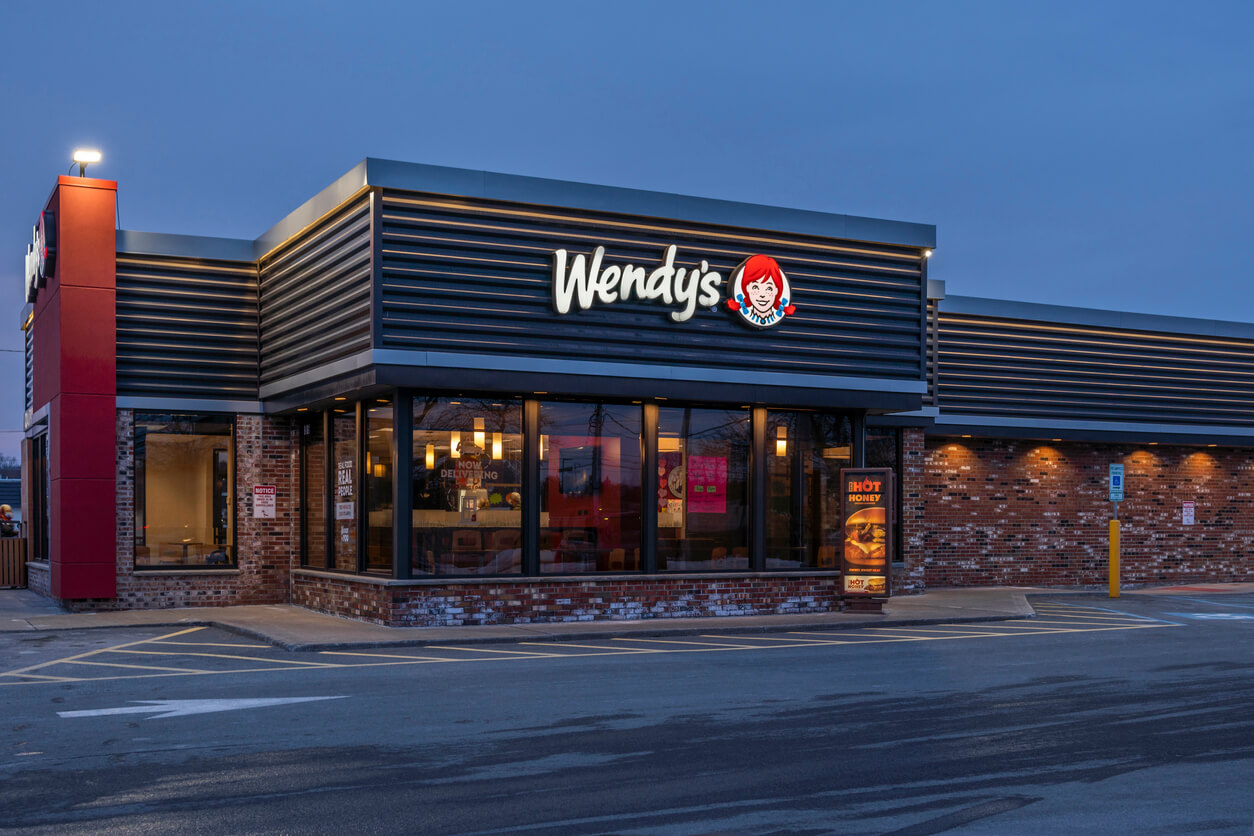 Wendy's restaurant entrance and drive through illuminated at night