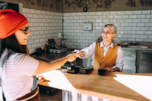 Woman paying for a meal at a quick serve restaurant